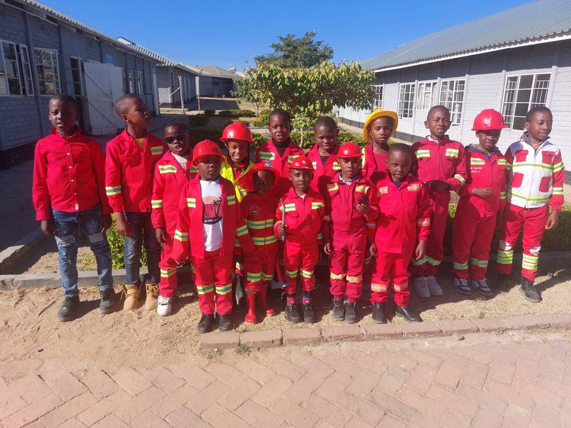 Quality Junior pupils in firefighter uniforms during a careers and community day